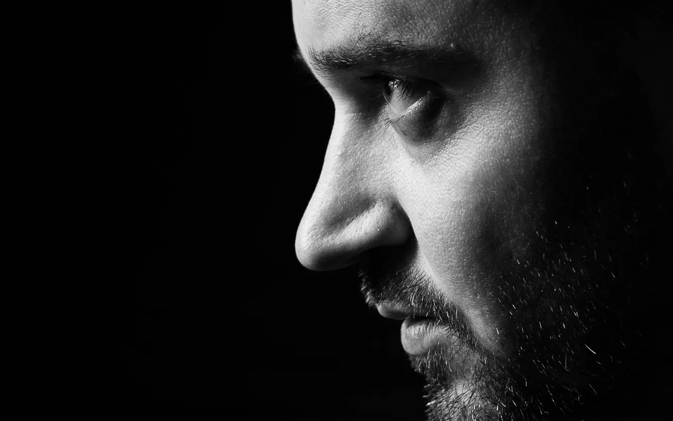 Dramatic black and white portrait with strong contrast lighting